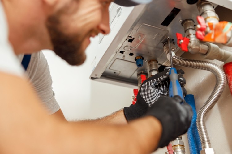 Plumber Repairing A Water Heater